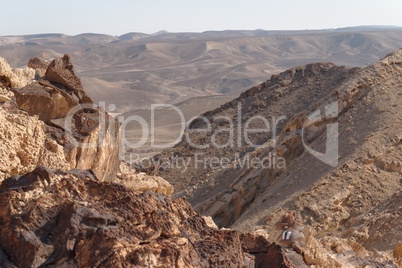 Jagged rocks on the edge of the cliff in the desert
