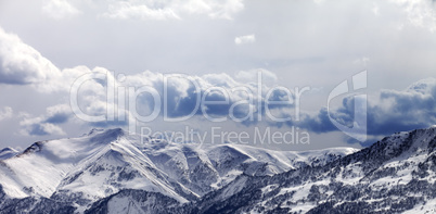 Panoramic view on mountains in evening and cloudy sky