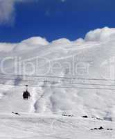 Gondola lift and off-piste slope at sun day