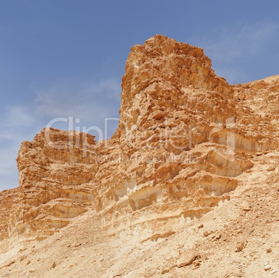 Scenic weathered orange  rocks in stone desert near the Barak canyon near the Dead Sea