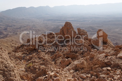 Jagged  rocks at the rim of desert canyon in the Small Crater (Makhtesh Katan) in Negev desert, Israel