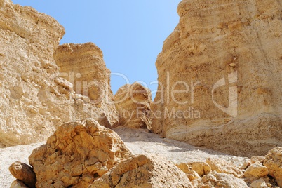Scenic weathered orange  rocks in stone desert near the Dead Sea