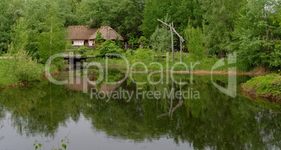 Farmer's house reflecting in a pond in open air museum, Kiev, Ukraine