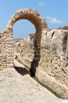 Ancient irrigation ditch and arch in Nahal Taninim archeological park in Israel