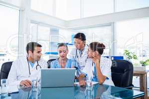 Team of doctors looking at laptop