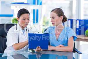 Doctor and nurse looking at clipboard