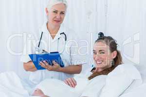 Happy pregnant woman having a doctor visit