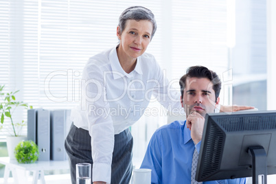 Business people working together and looking at camera