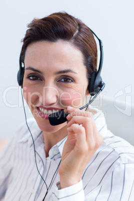 Portrait brunette businesswoman smiling using headphone