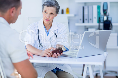 Female doctor holding a box of pills