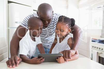 Happy family on table with digital tablet