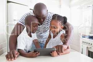 Happy family on table with digital tablet
