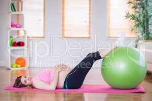 Pregnant woman doing exercise with exercise ball