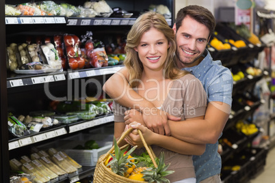 Portrait of smiling bright couple buying food products