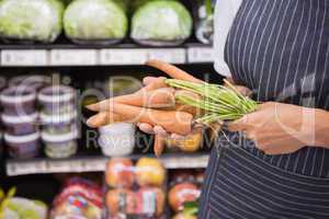 Close up view of woman showing carrot