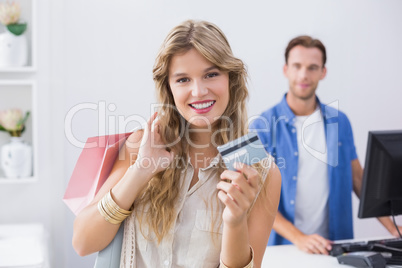 A pretty blonde woman showing her credit cards