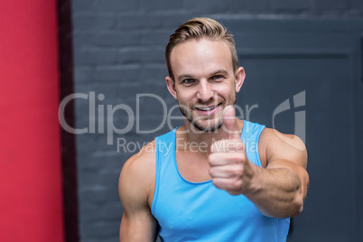 Muscular man gesturing thumb up