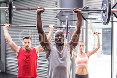 Three muscular athletes lifting barbells