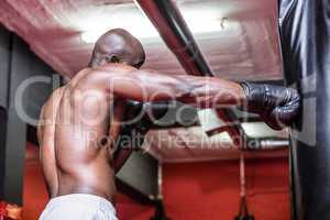 Young Bodybuilder boxing a bag