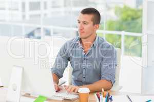 Handsome businessman typing on a computer