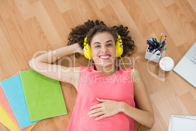 Young creative businesswoman enjoying music