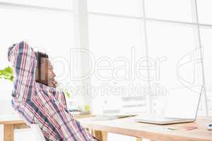Young businessman relaxing at his desk