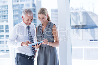 Business people discussing over a digital tablet