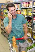 Smiling man buy food and phoning