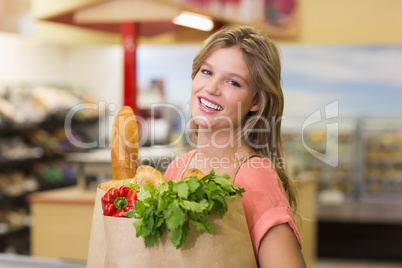 Portrait of pretty smiling blonde woman buying food products