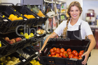 Portrait of a staff woman holding a box with a fresh vegetables