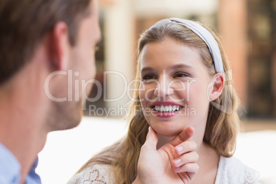 Handsome man touching his girlfriend face