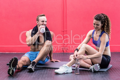 Sitting muscular couple talking together