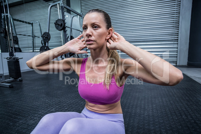 Muscular woman doing abdominal crunch
