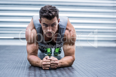 A muscular man on plank position