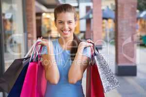 Young happy woman holding her shopping bags