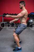 Muscular man exercising with rope