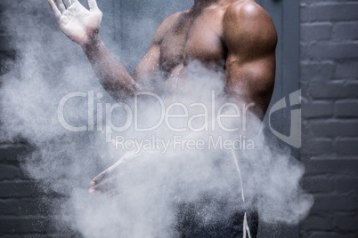 Young Bodybuilder shaking Chalk off his hands