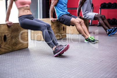 Three young Bodybuilders doing exercises