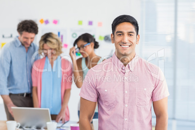 Casual business team having a meeting using laptop