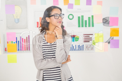 Pretty designer looking at post its on window