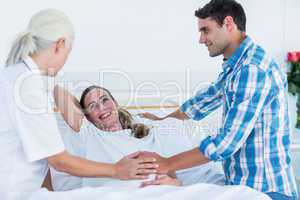 Pregnant woman and her husband having a doctor visit