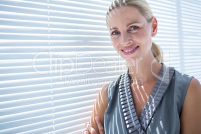 Smiling businesswoman standing in the office