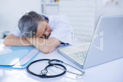 Female doctor sleeping on desk