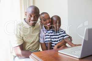 Happy smiling family using laptop