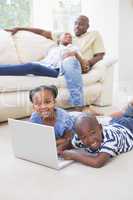 Happy siblings using their laptop