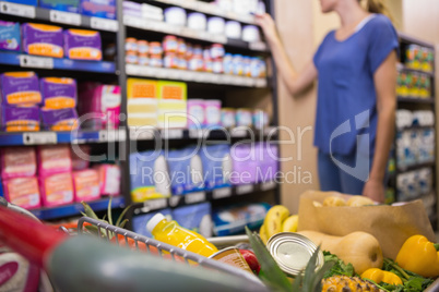 Woman looking at product on self