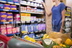 Woman looking at product on self