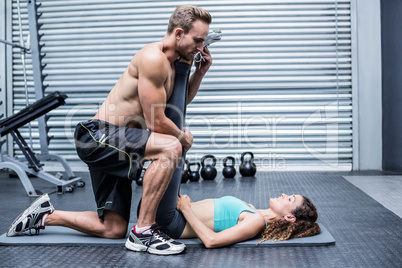 Muscular couple doing a leg stretching