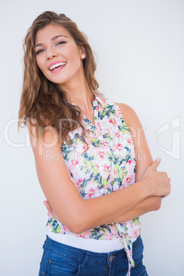 Portrait of smiling young woman with arms crossed