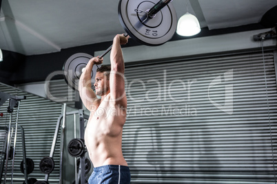 Muscular man lifting a barbell